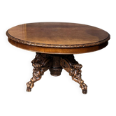 Grande table à manger extensible de style chasse avec quatre figures de renard sur le pied.