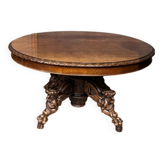 Large extendable dining table in hunting style with four fox figures on the leg.