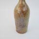Brown ceramic/stoneware bottle with chiseled floral pattern