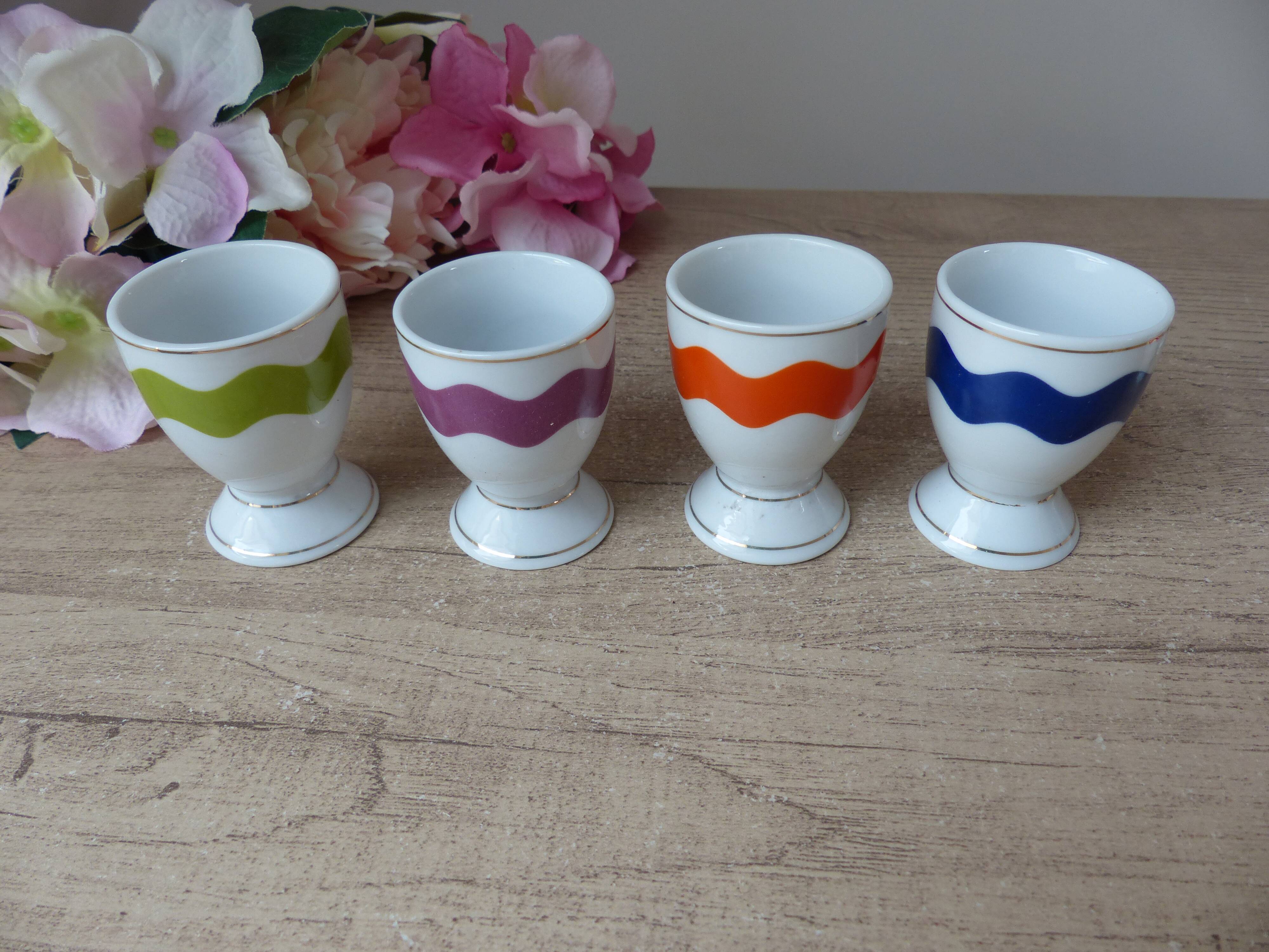 Set of 4 egg cups with spoons, colourful vintage salt and pepper shakers.