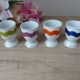 Set of 4 egg cups with spoons, colourful vintage salt and pepper shakers.