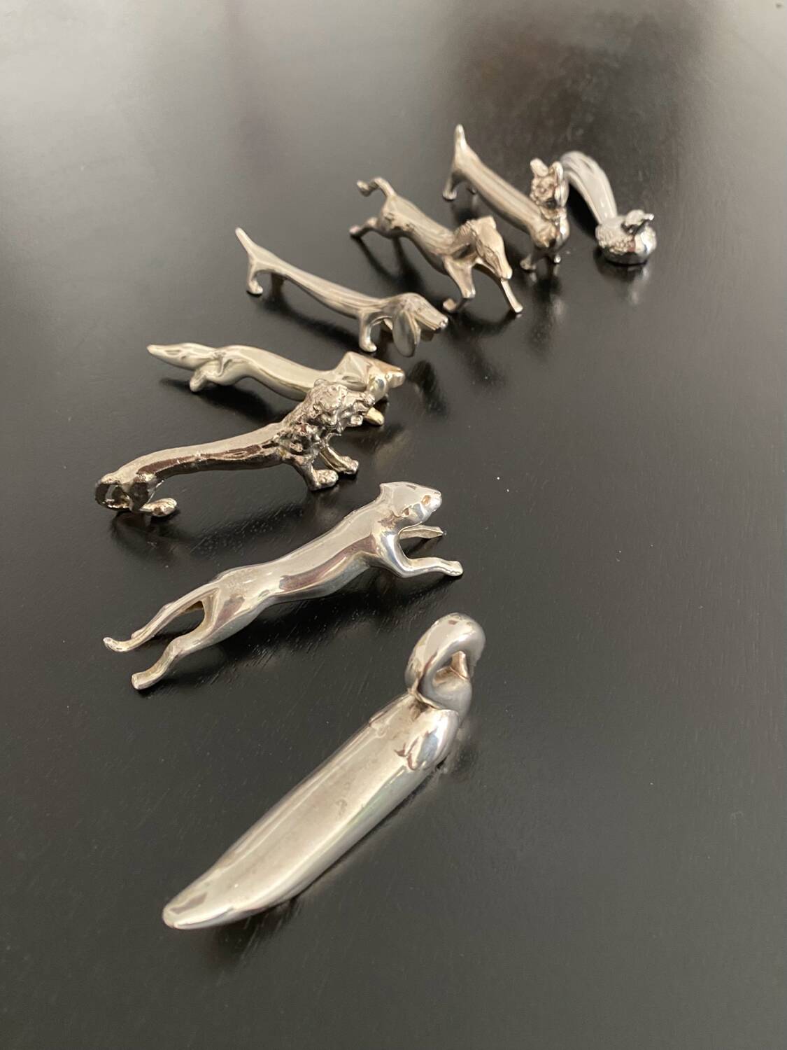 8 various animal knife holders in silver-colored metal
