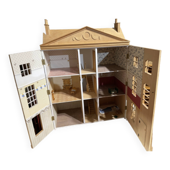 Large wooden dollhouse with miniature furniture