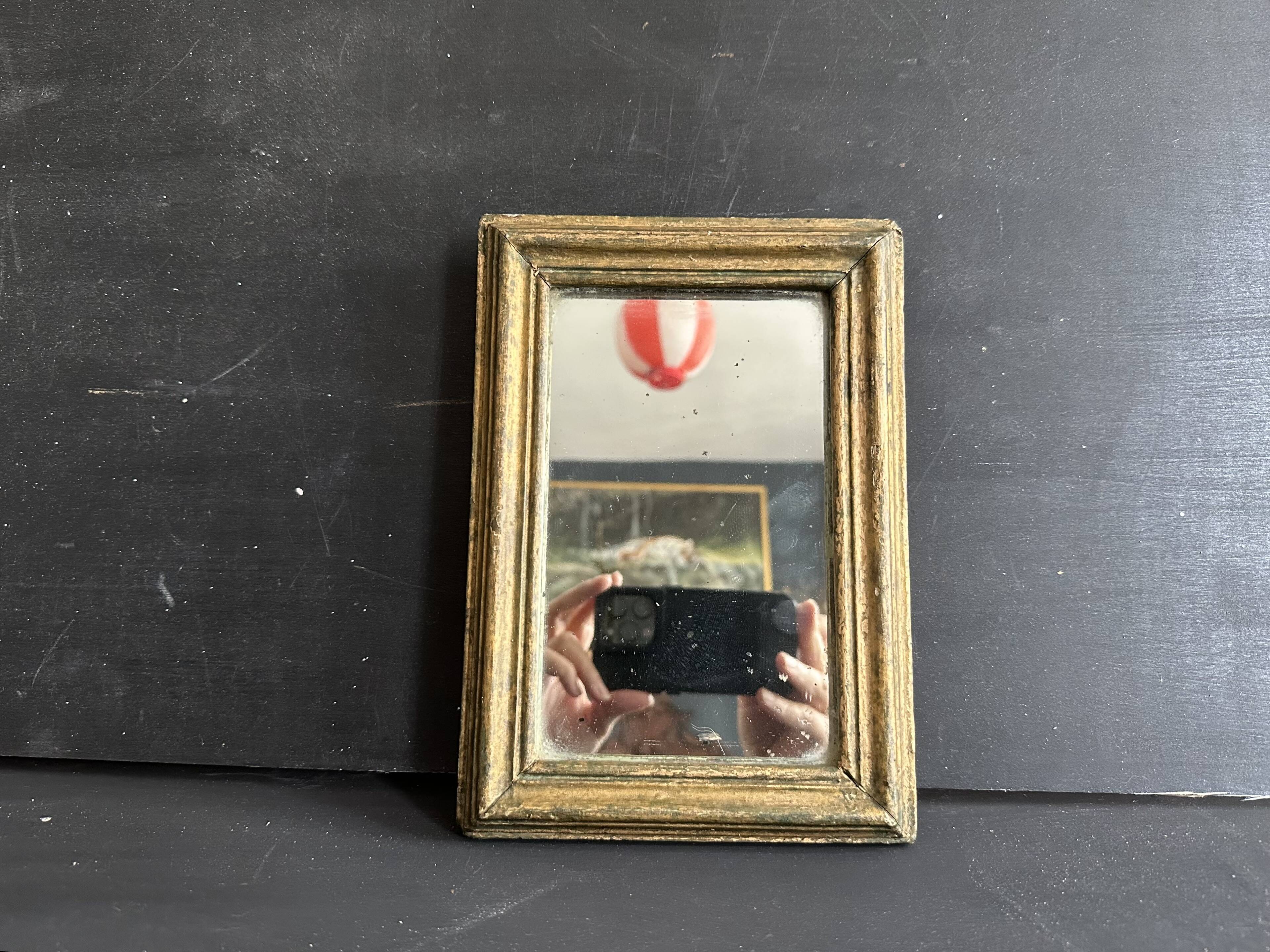Miniature mirror from the 18th century in gilded wood, mercury glass.