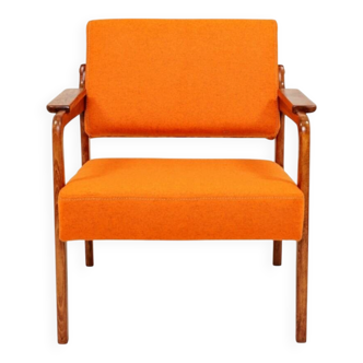 Vintage armchair in papaya orange wool from the 1960s.