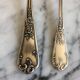 Duo of silver metal spoons