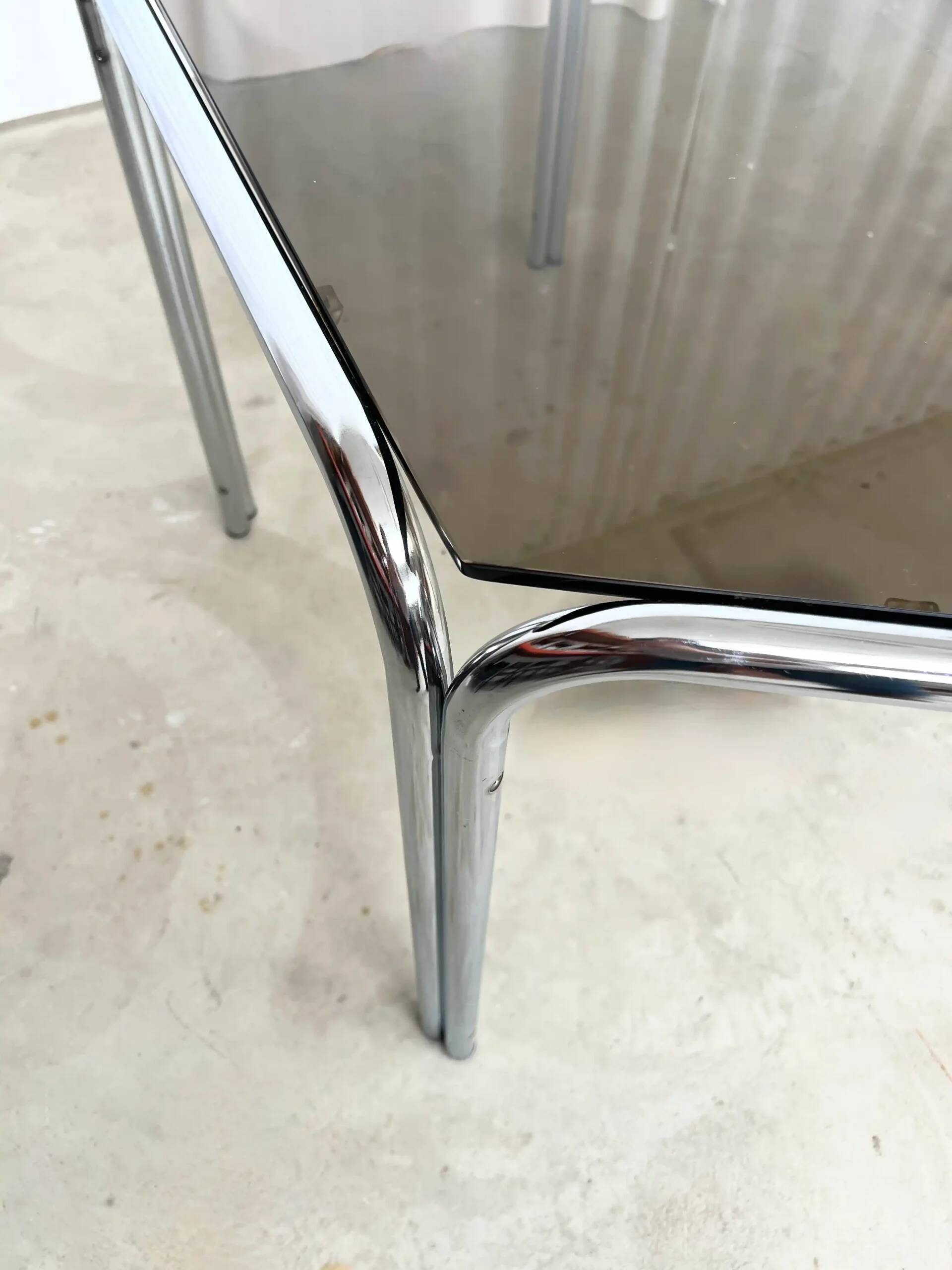 Vintage hexagonal table with smoked glass top and chrome metal structure.