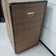 Wardrobe trunk on casters in mahogany and woven rattan.