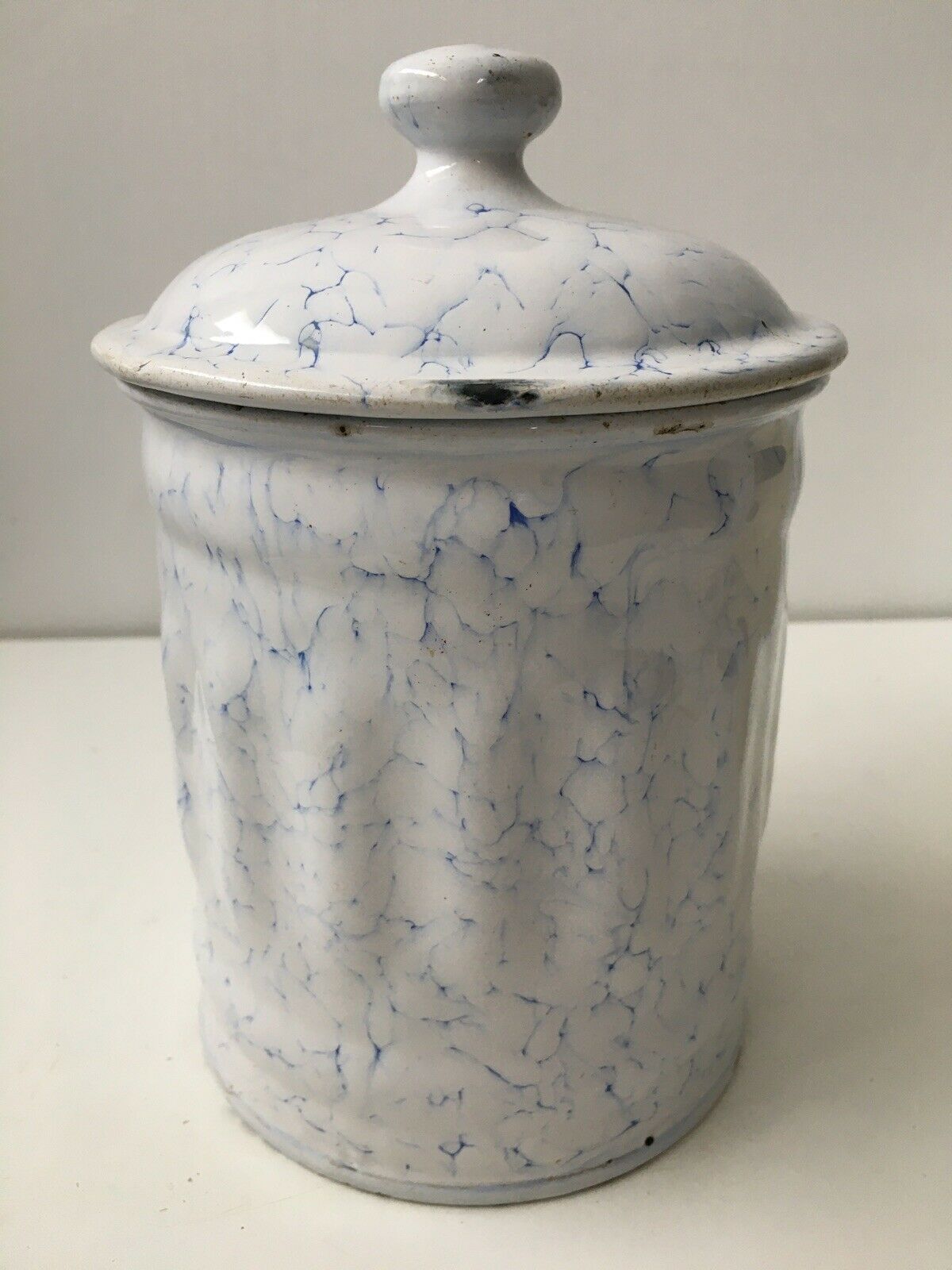 Vintage coffee pot in white enamelled iron and blue retro kitchen decoration