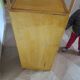Storage column, wooden bookshelf and woven rattan.