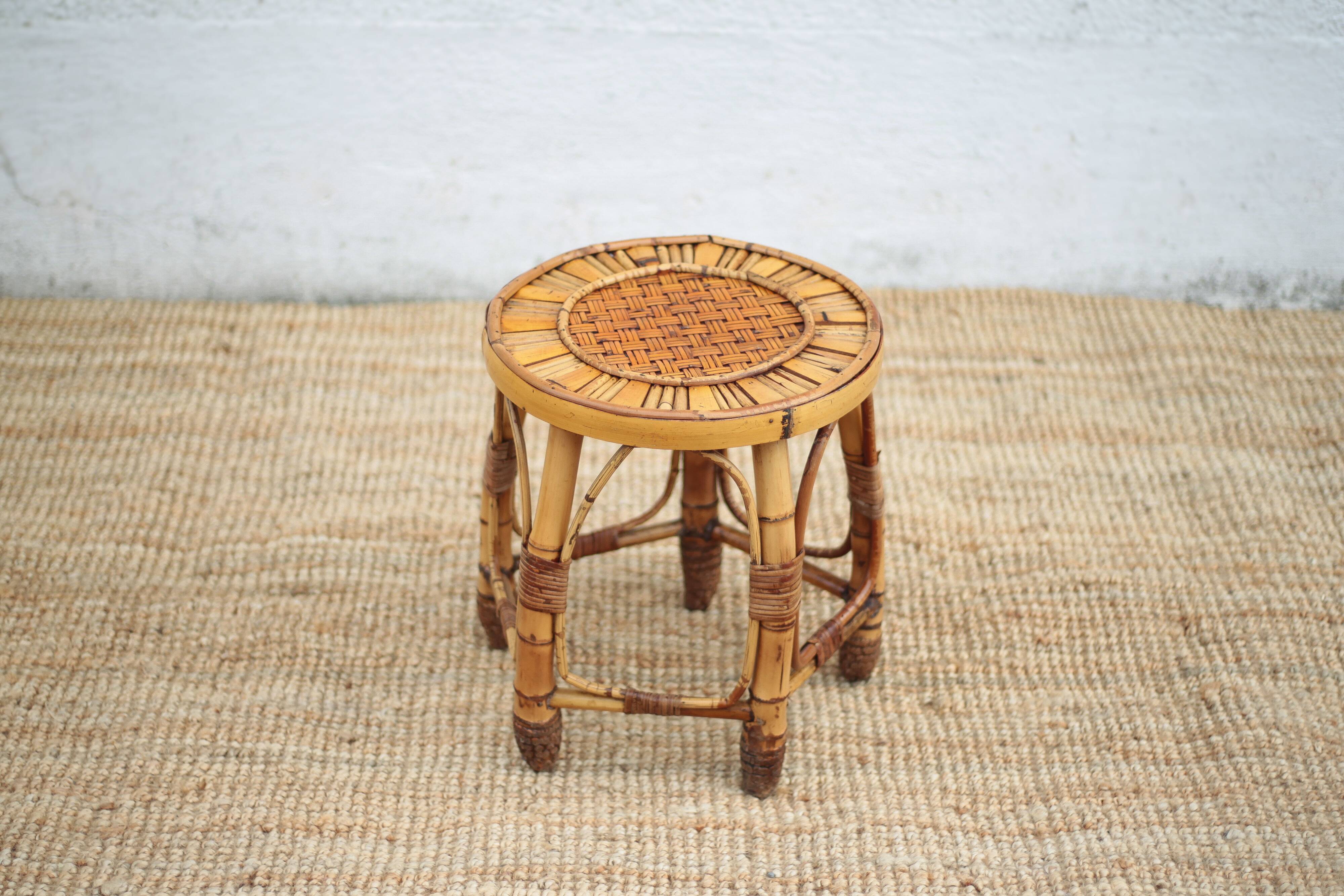Vintage bamboo stool, woven rattan plant stand, interior decoration.
