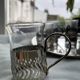 6 small glasses in their silver metal holder, with handle