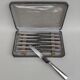 Box of 12 table knives in silver metal, art deco period.