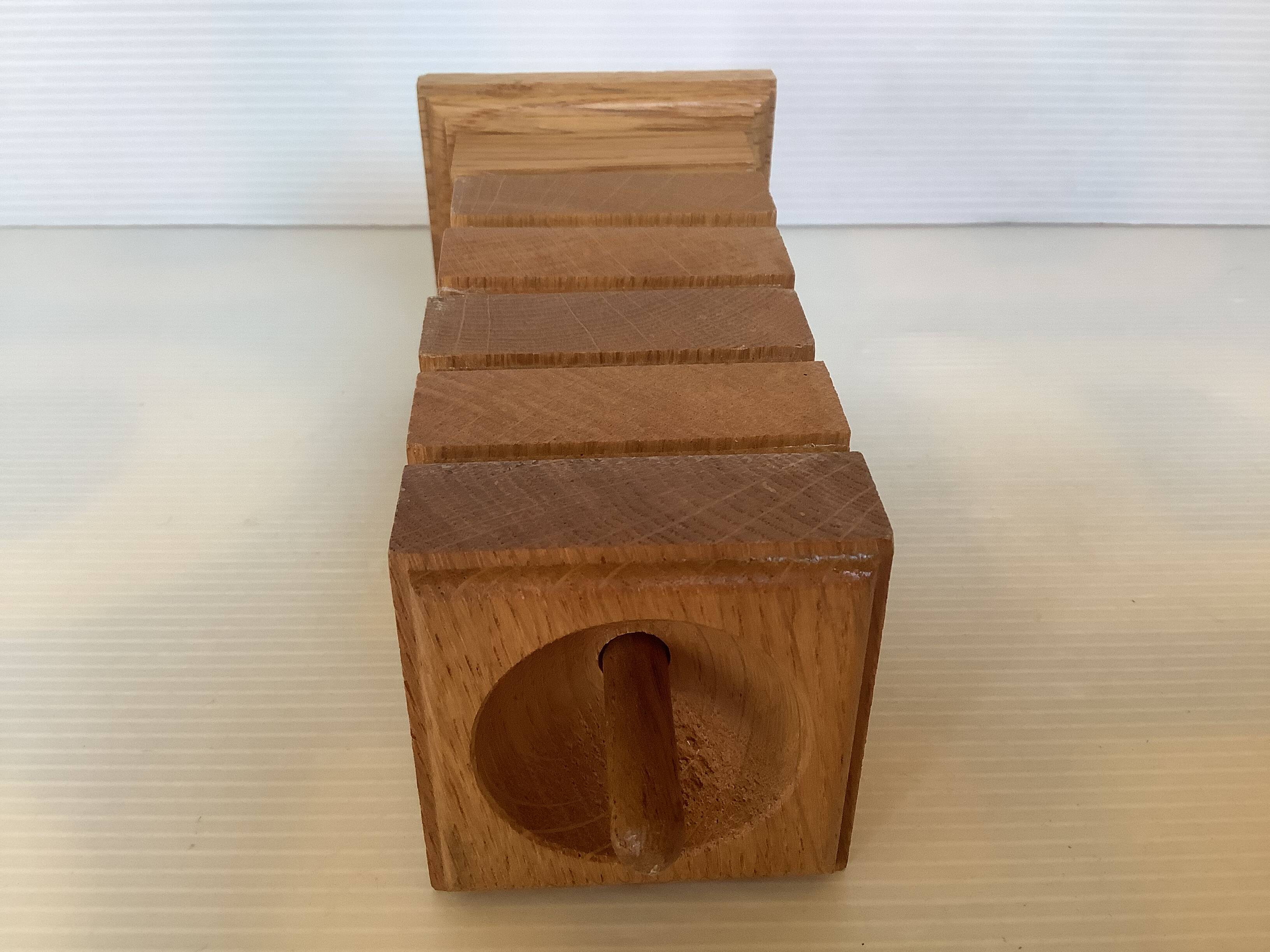 Six wooden egg cups and their Scandinavian style support