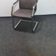 One of two vintage Leather and metal arm chairs.