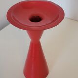 Vintage design candlestick in red metal in the shape of an hourglass