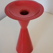 Vintage design candlestick in red metal in the shape of an hourglass