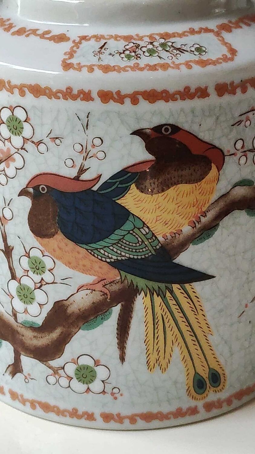 Japanese ceramic teapot. bird/paradise motifs/cherry trees. bamboo/rattan braided handle