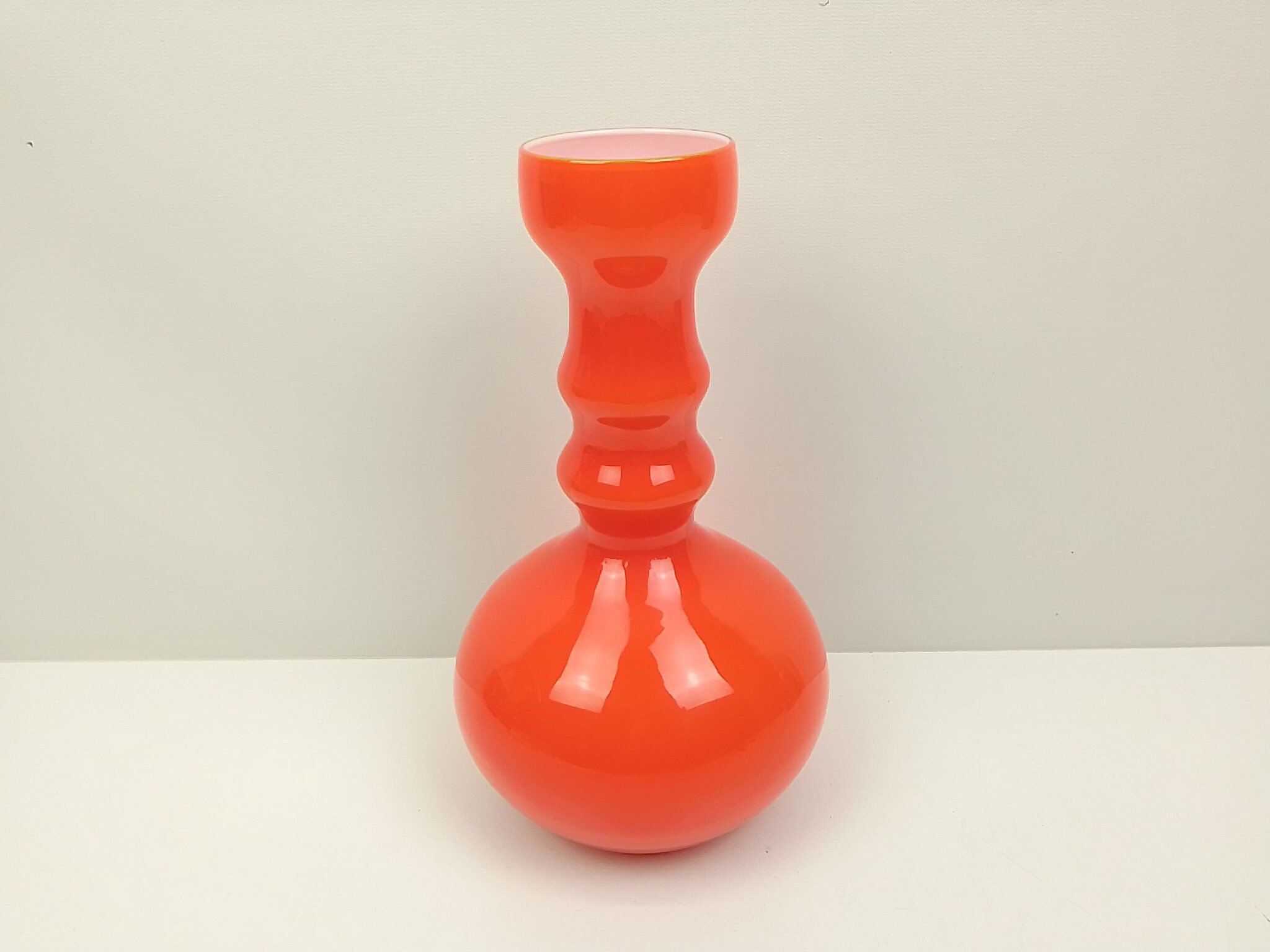 Orange glass vase and white interior
