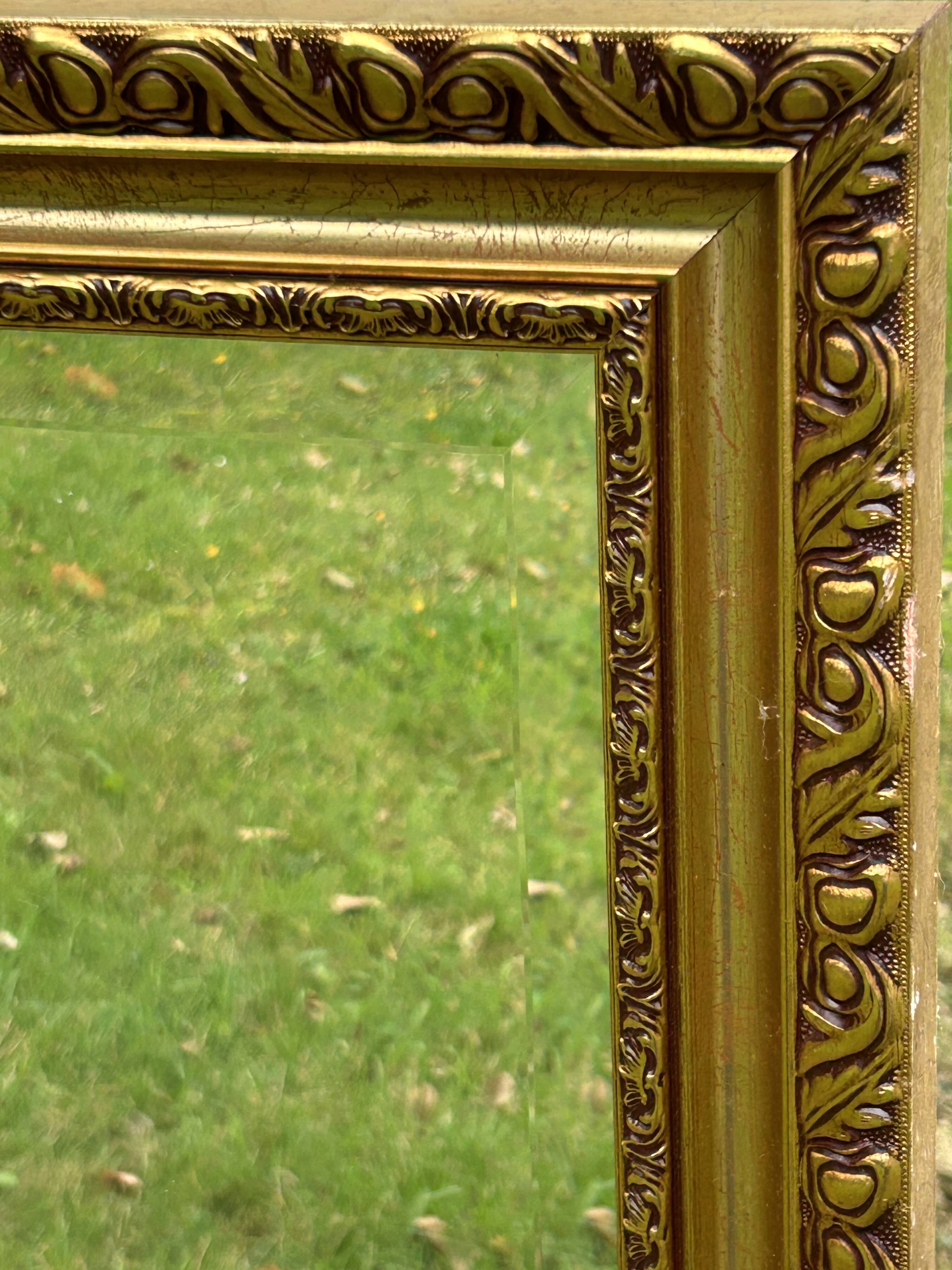 Large beveled mirror in wood and gilded stucco