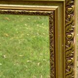 Large beveled mirror in wood and gilded stucco