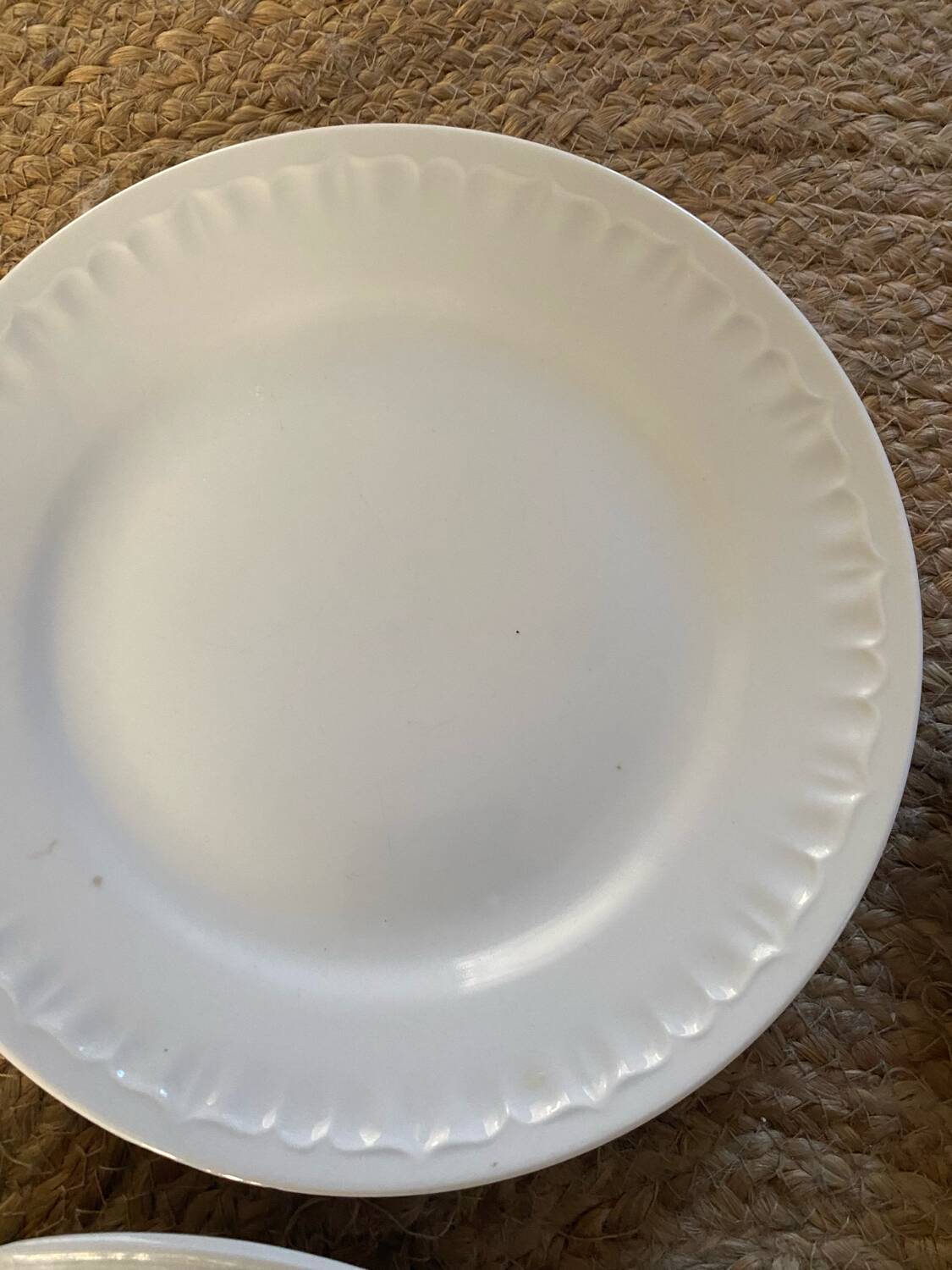 5 mismatched old white plates.