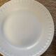 5 mismatched old white plates.