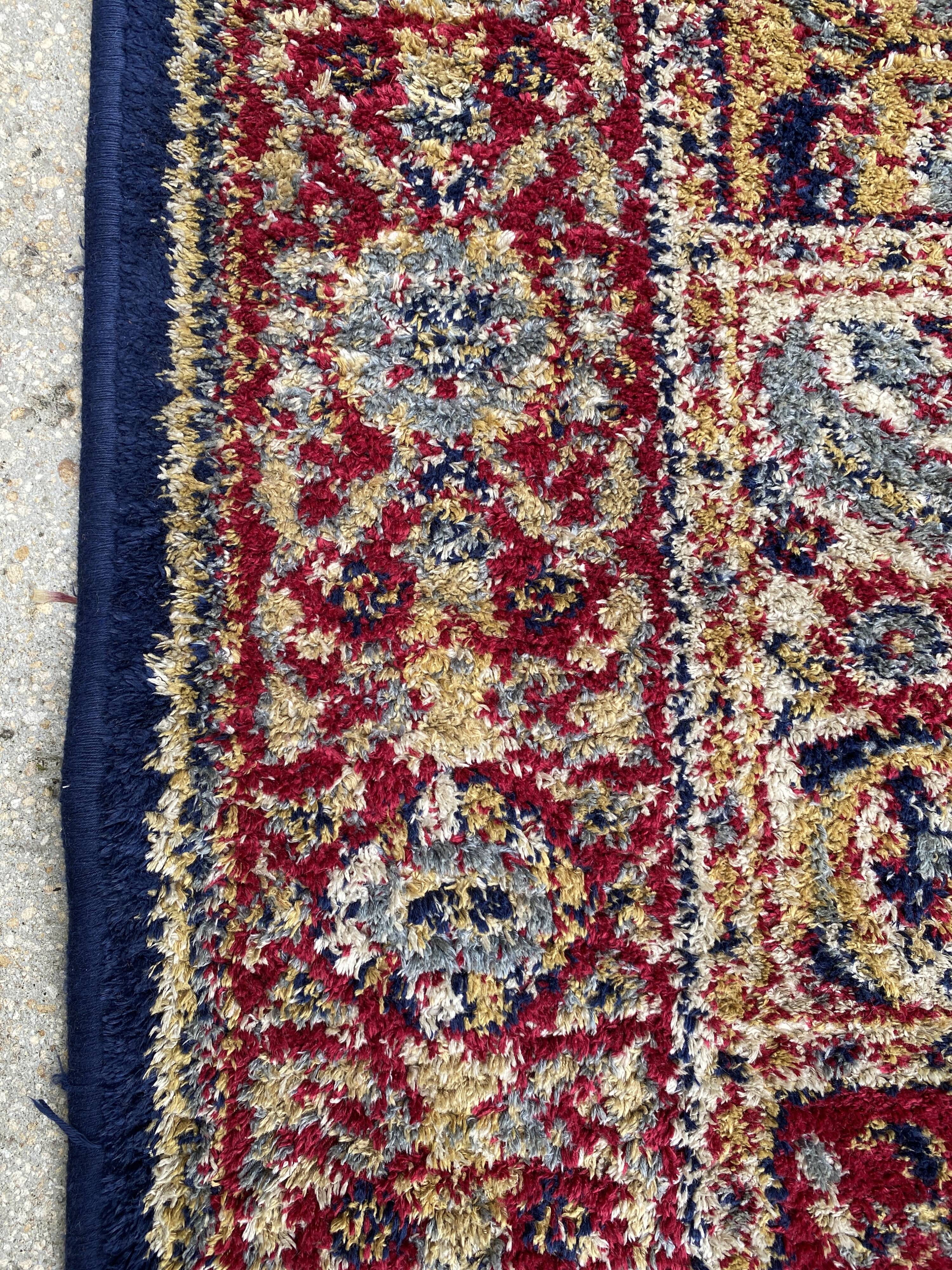Vintage mechanical Turkish rug with box decoration on a red and navy blue background 139 x 68 cm