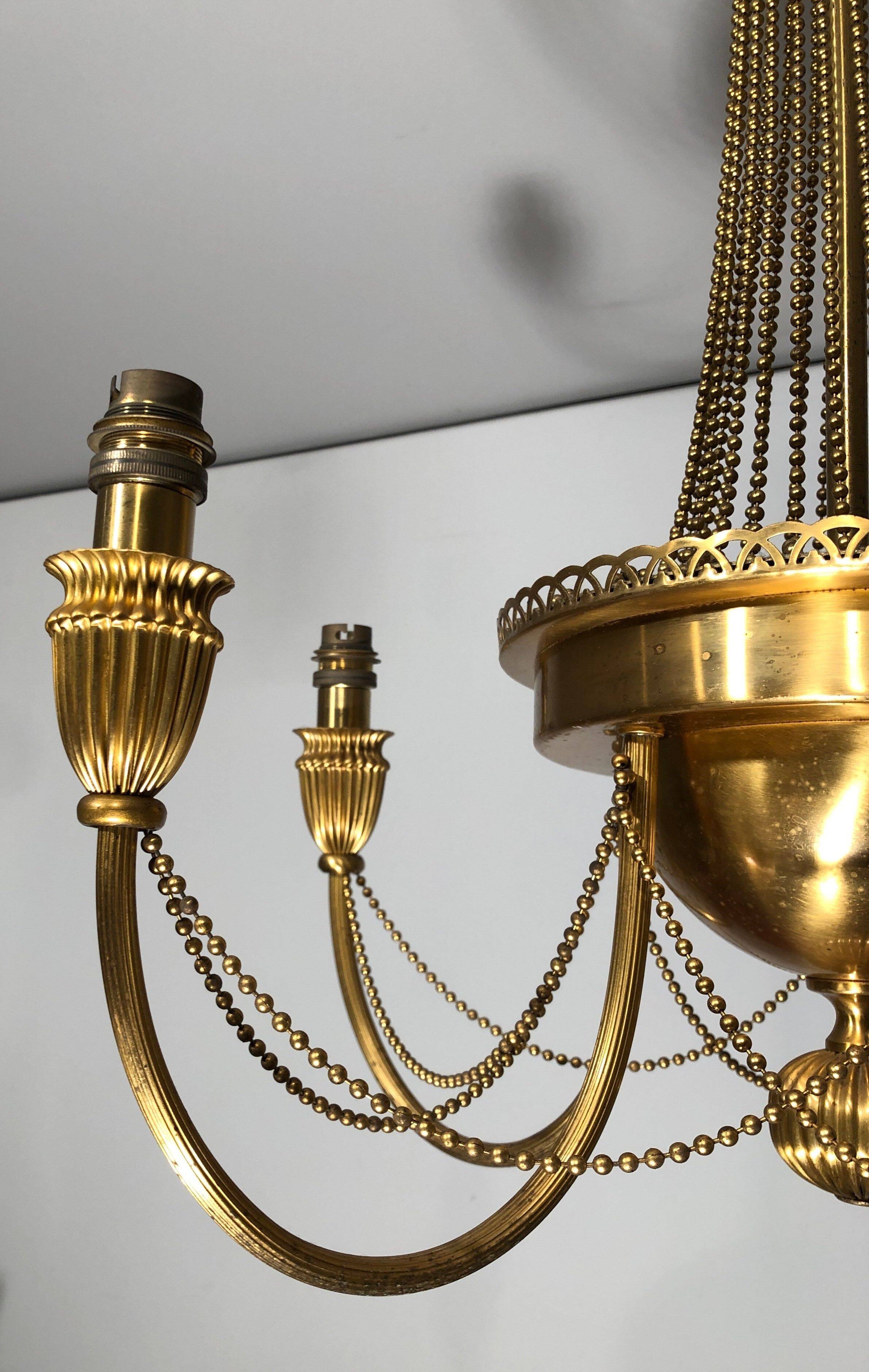 Neoclassical style brass chandelier decorated with pearl garlands