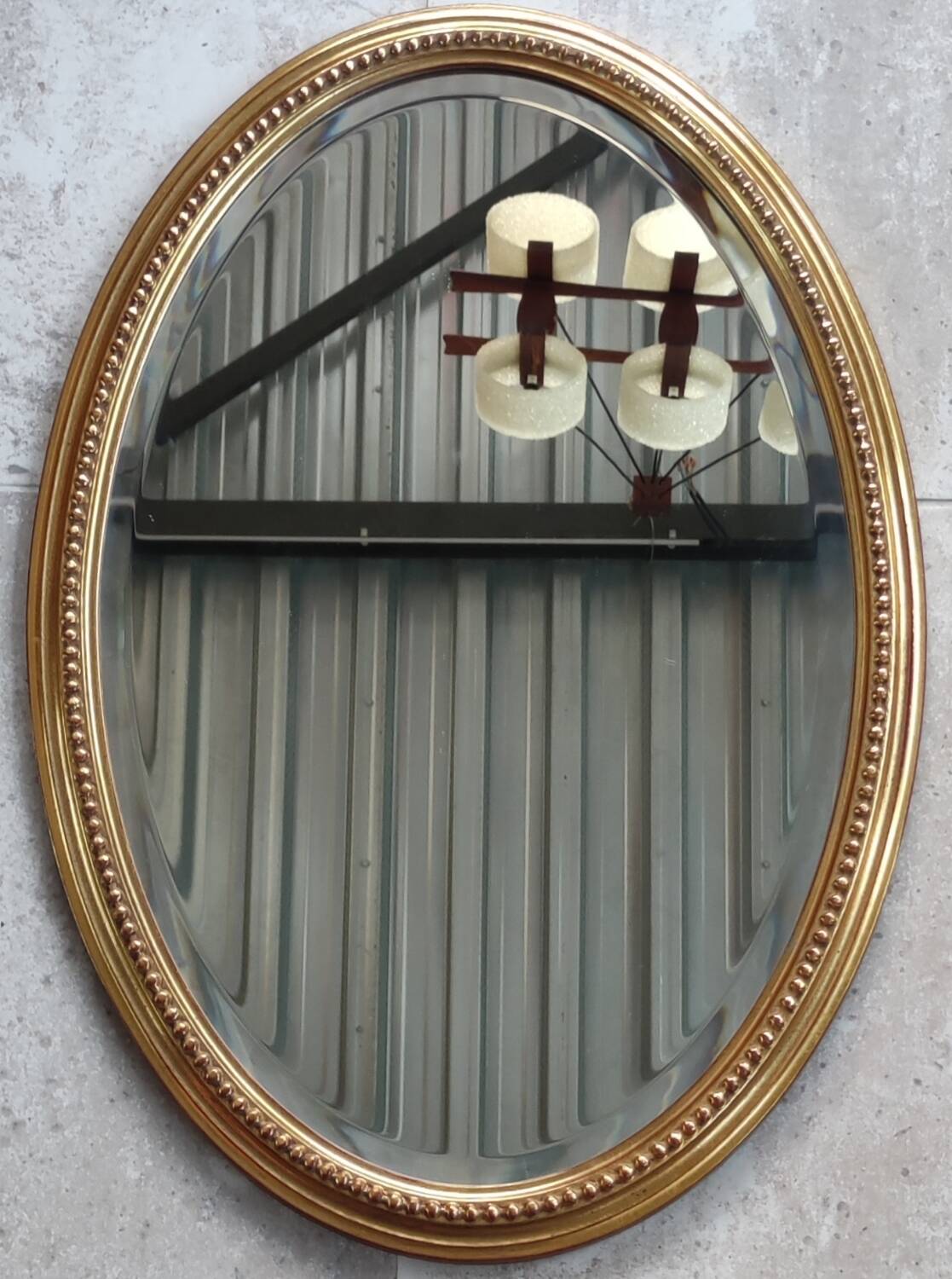 Old oval beveled golden mirror