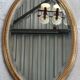 Old oval beveled golden mirror