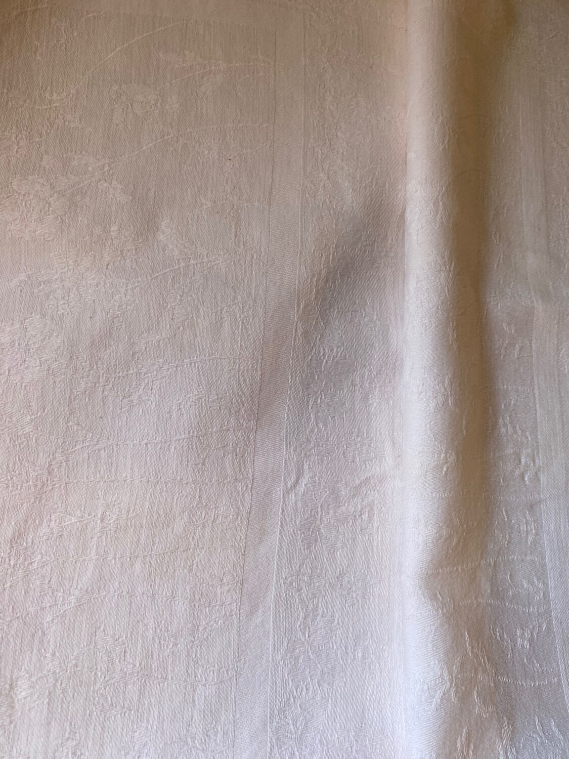 Pair of embroidered white cotton tea towels.