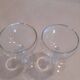 Two small crystal champagne glasses with twisted stems.