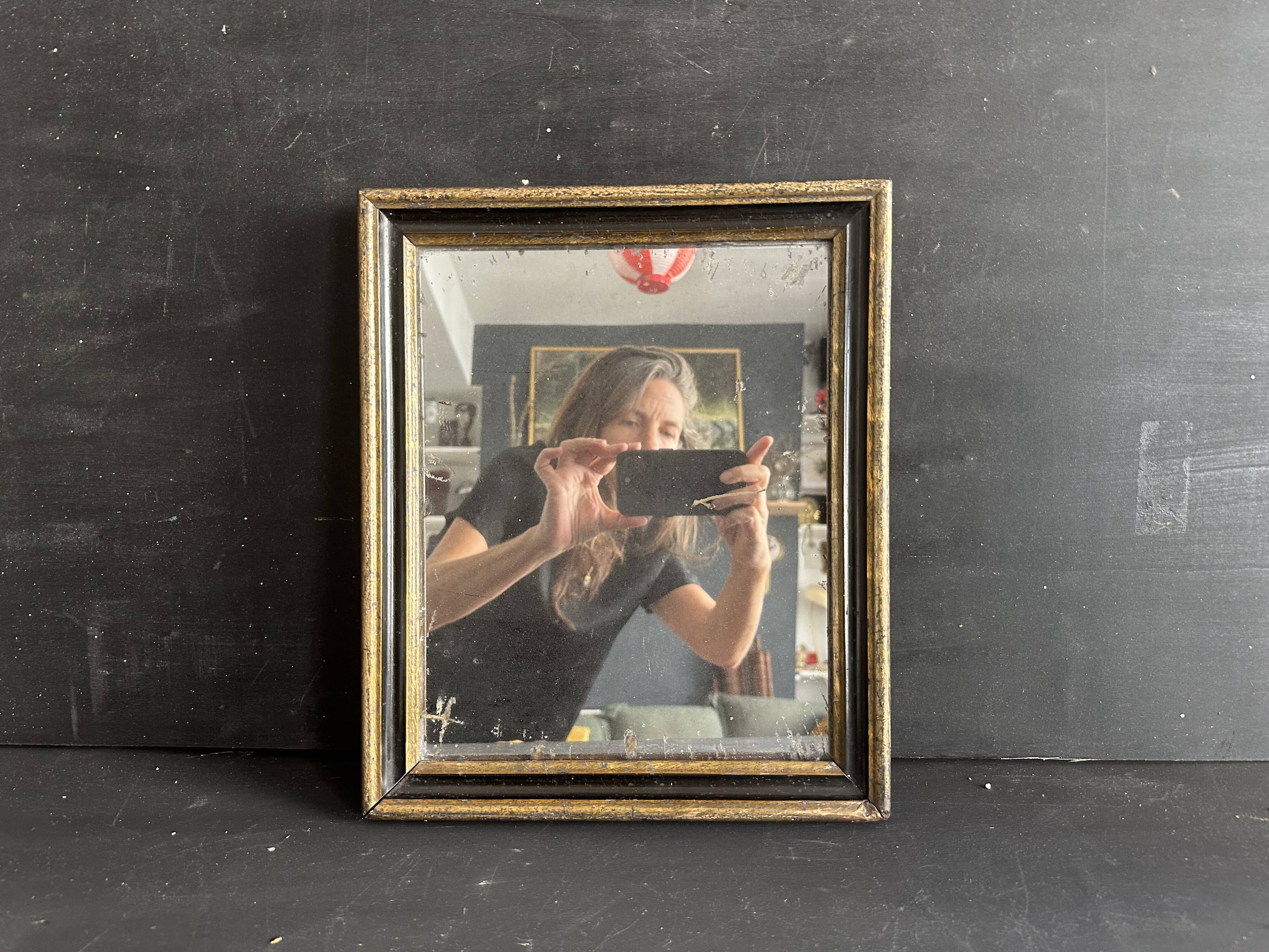 Miroir Napoléon III en bois noir et doré, XIXe siècle