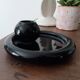 Vintage black ceramic candle holder on a bowl