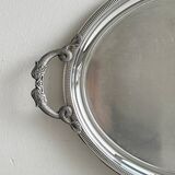 Large stainless steel serving platter with fish-shaped handles.