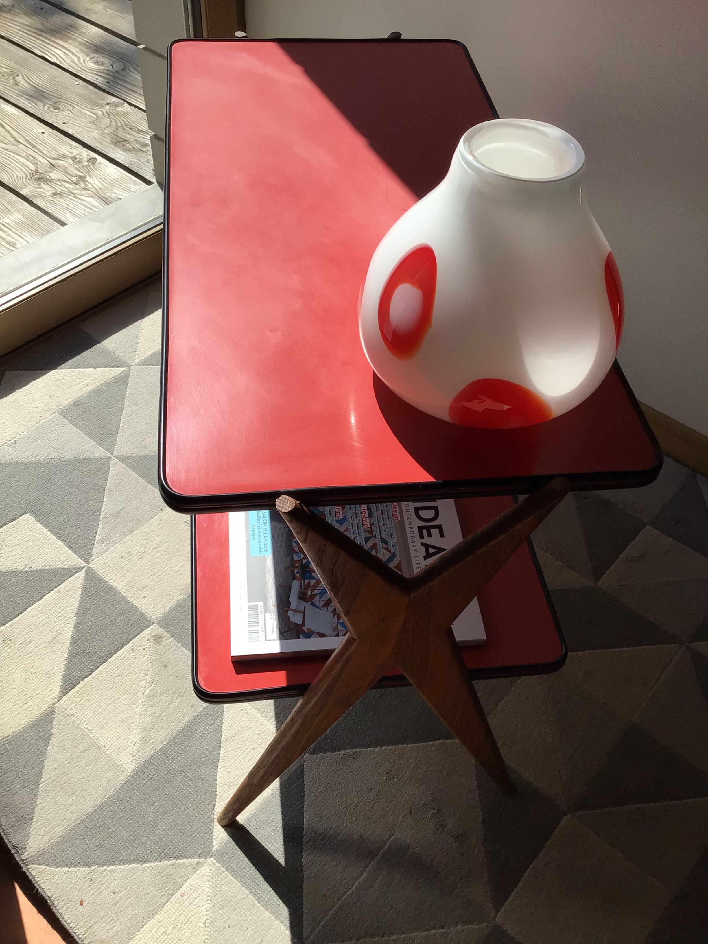 Double-footed red Formica wood spindles console