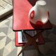Double-footed red Formica wood spindles console