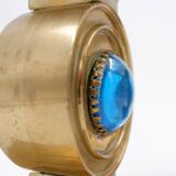 Pair of brass candlesticks decorated with a blue stone inlaid in the center