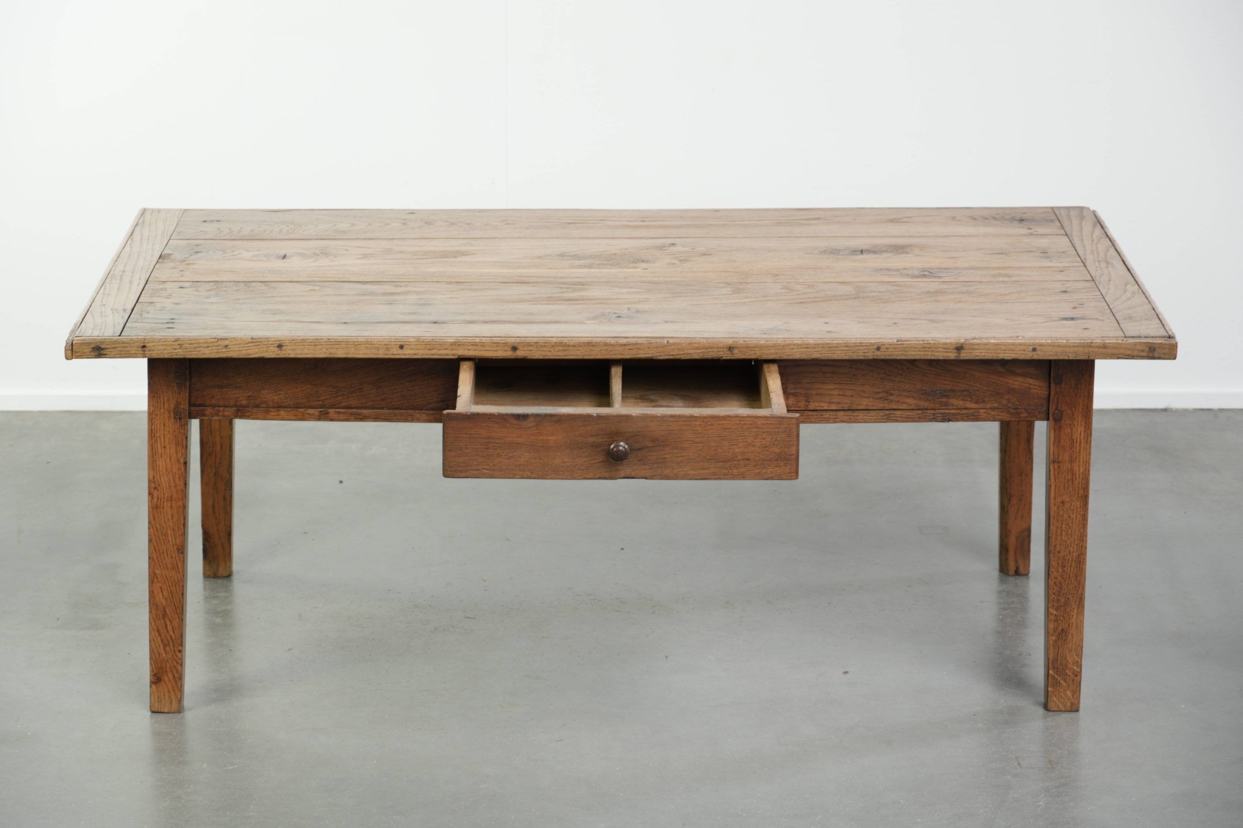 Antique pinewood coffee table with a drawer and a rural appearance