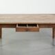 Antique pinewood coffee table with a drawer and a rural appearance