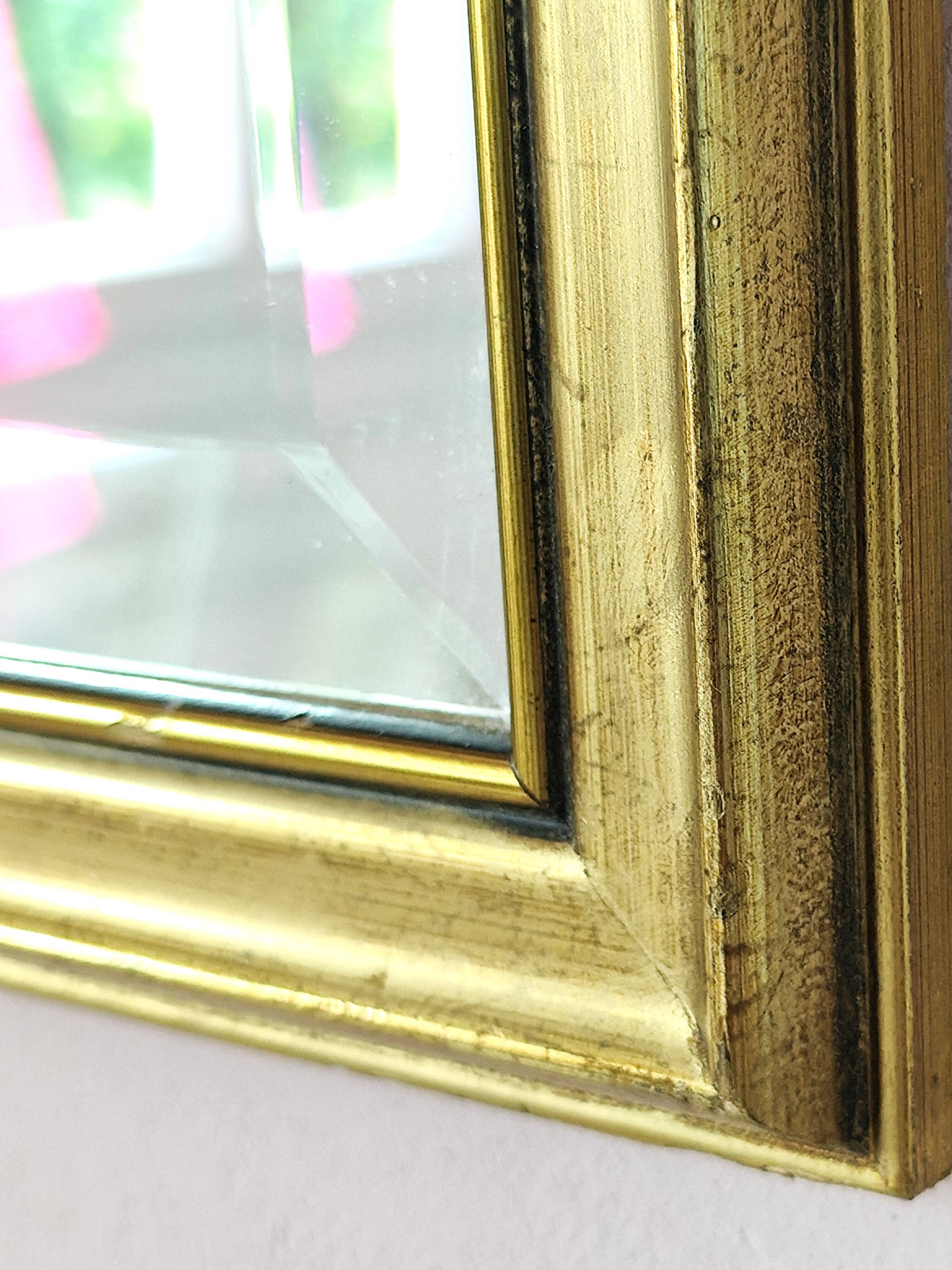 Rectangular gold mirror with bevelled glass.