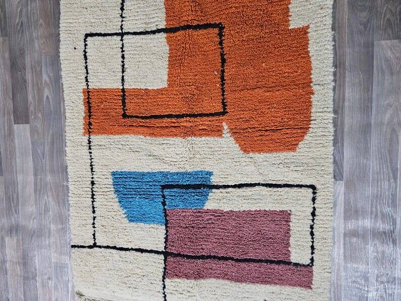 Traditional handmade wool Berber rug with colourful patterns.