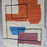 Traditional handmade wool Berber rug with colourful patterns.