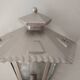 Half grey metal wall sconce and 3 windows