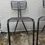 Pairs of perforated metal chairs by René Malaval