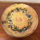 Vintage round ceramic plate with floral decoration.