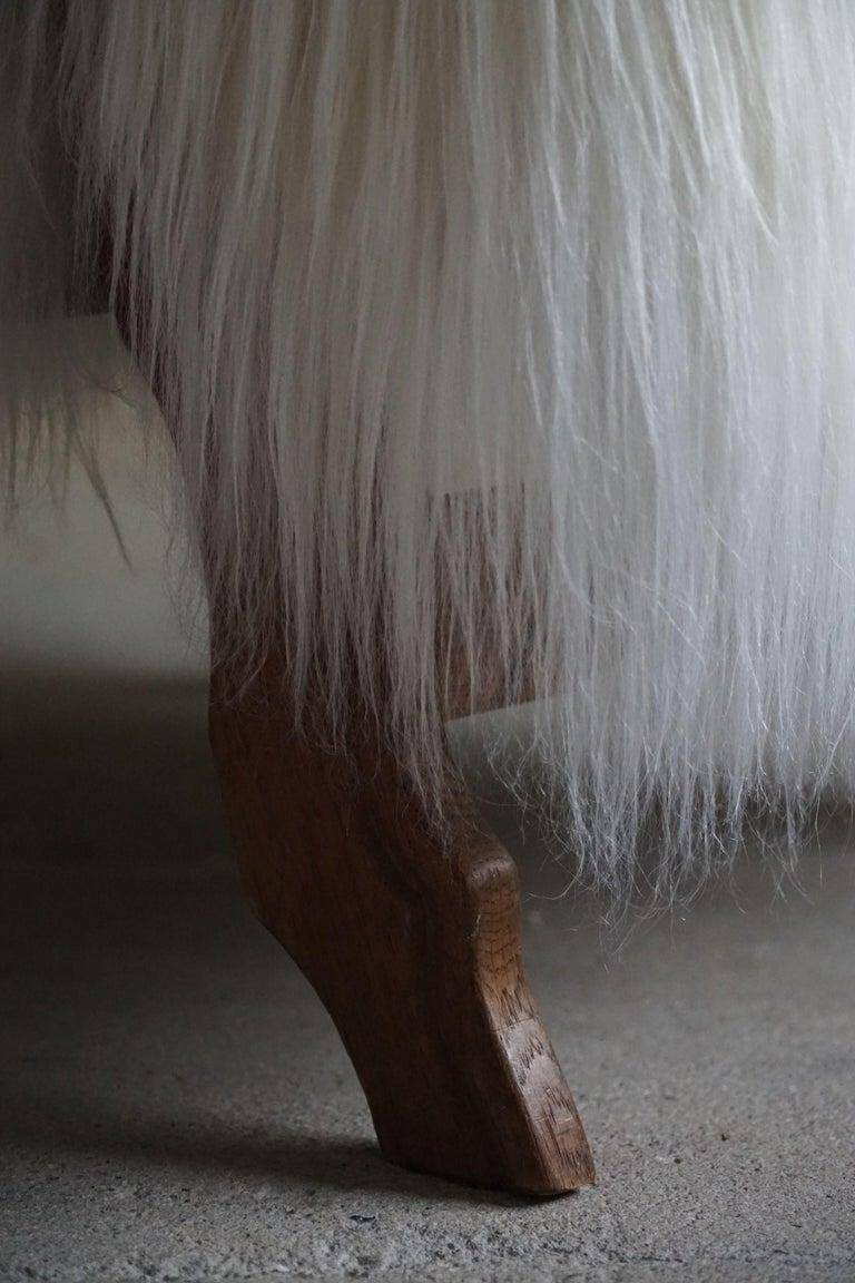 Pair of Scandinavian armchairs in oak and long-haired Icelandic sheepskin by Henning Kjærnulf, 1950.