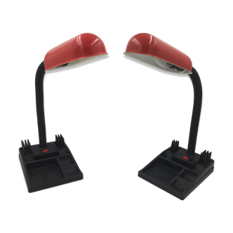 Duo of red and black flexible desk lamps with pencil holder