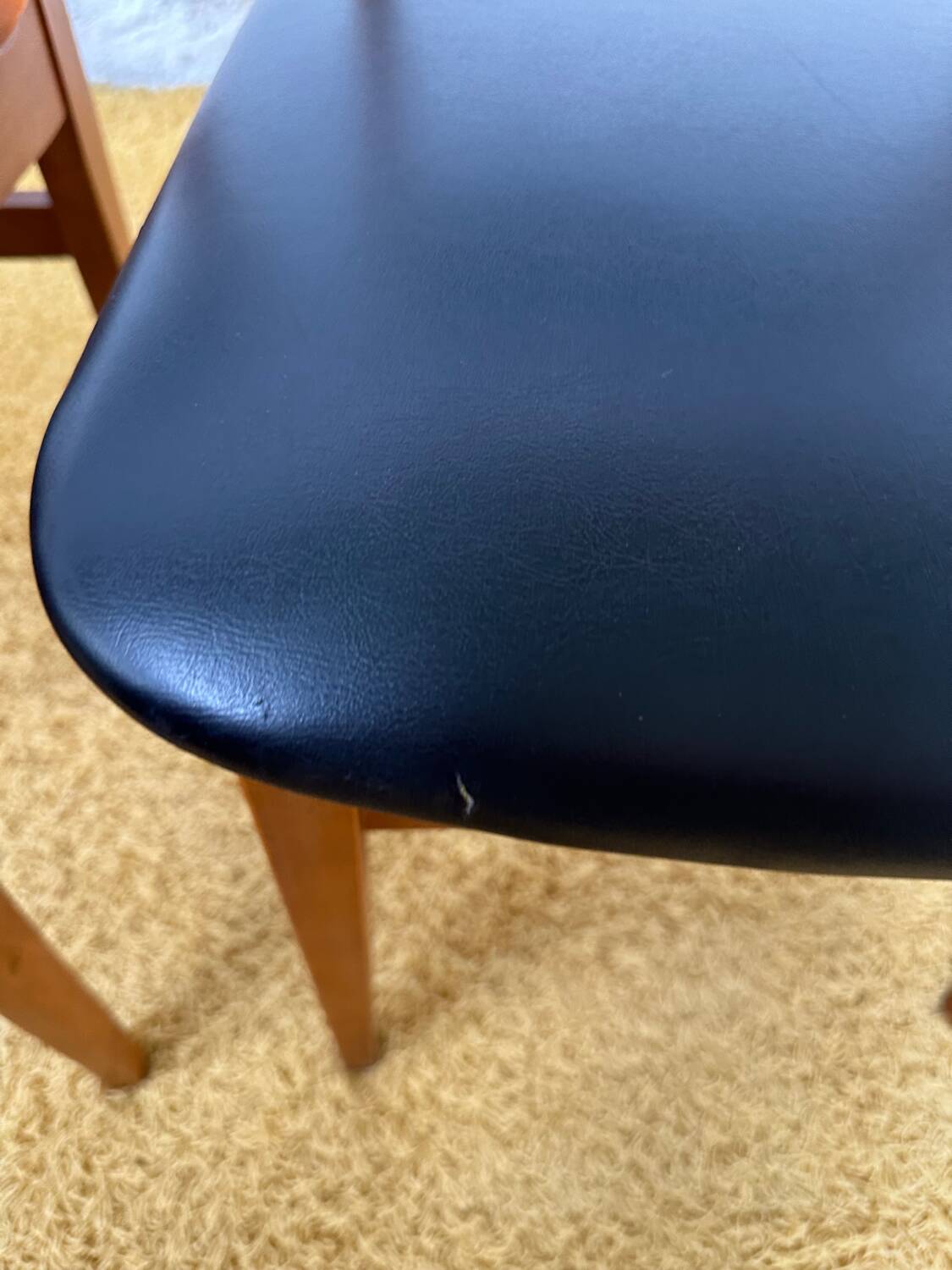 4 Scandinavian chairs in teak and black faux leather.